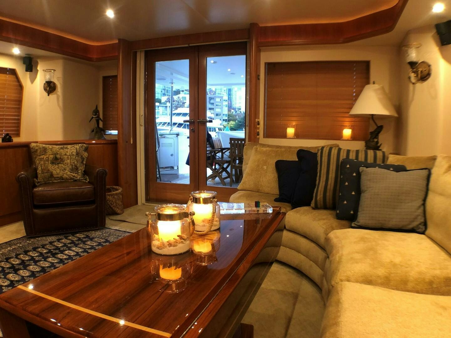 a living room with a table and couches aboard ENCHANTRESS Yacht for Sale