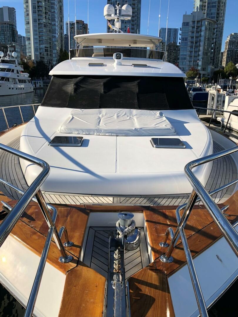 a white yacht in a harbor aboard ENCHANTRESS Yacht for Sale