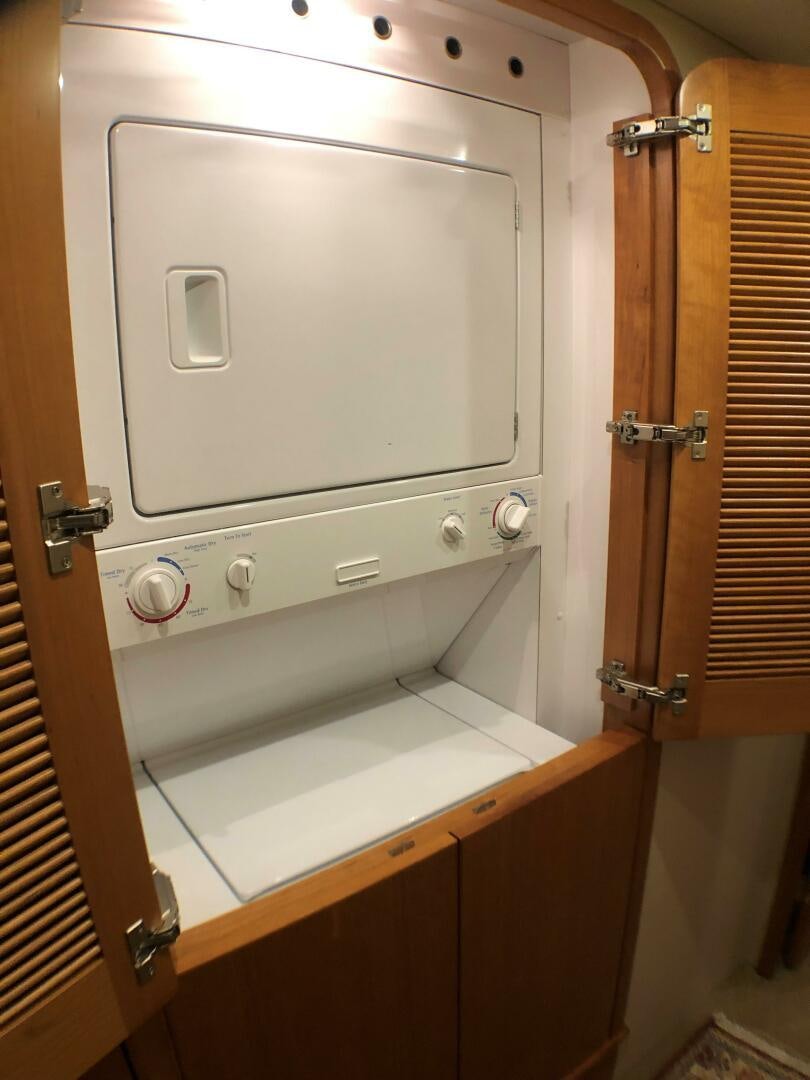 a white cabinet with knobs aboard ENCHANTRESS Yacht for Sale
