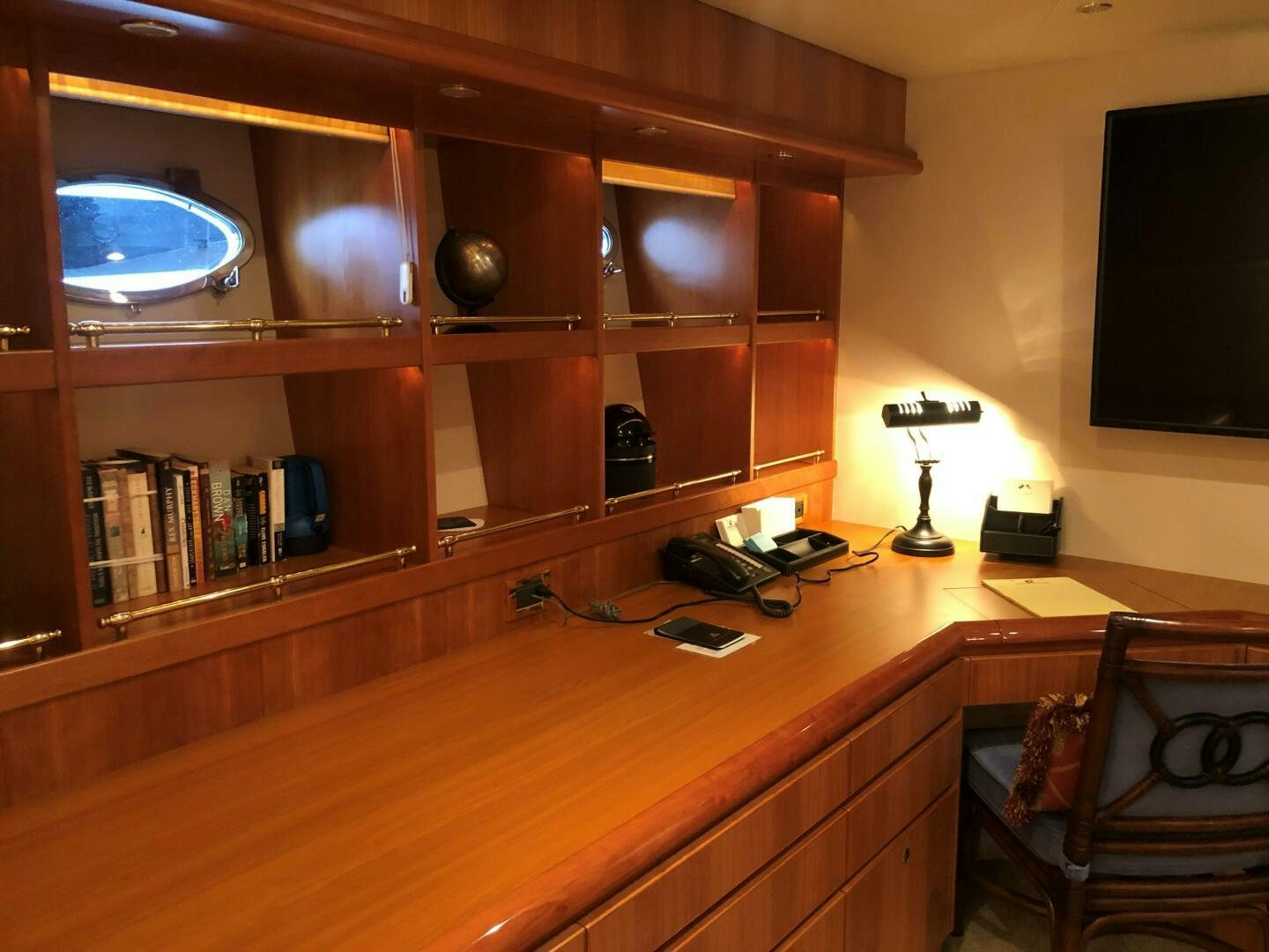 a desk with a computer and a television on it aboard ENCHANTRESS Yacht for Sale