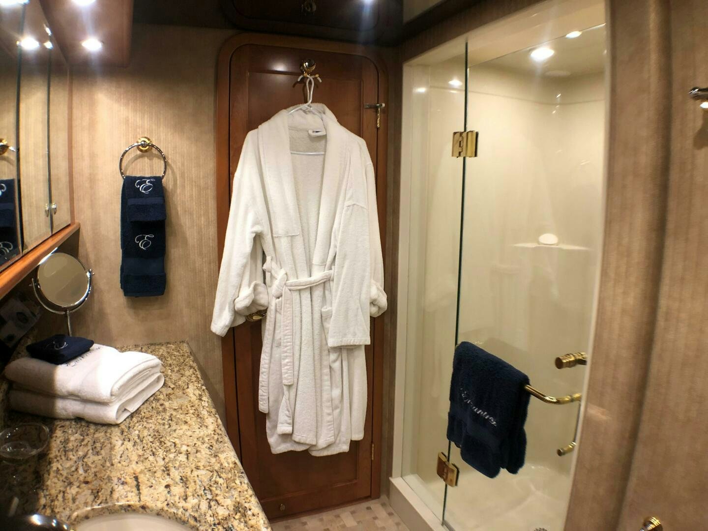 a bathroom with a robe on the wall aboard ENCHANTRESS Yacht for Sale