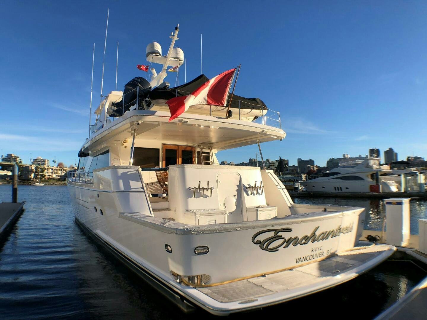 a large white boat with a red and white flag on it aboard ENCHANTRESS Yacht for Sale