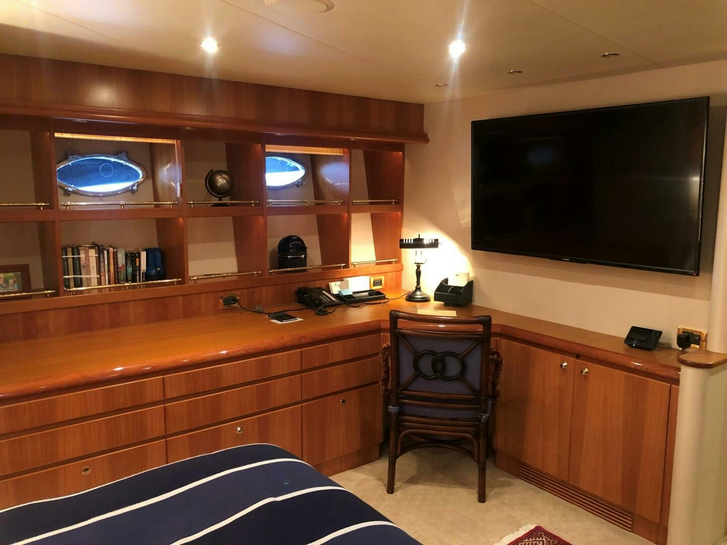 a room with a tv and a bed aboard ENCHANTRESS Yacht for Sale