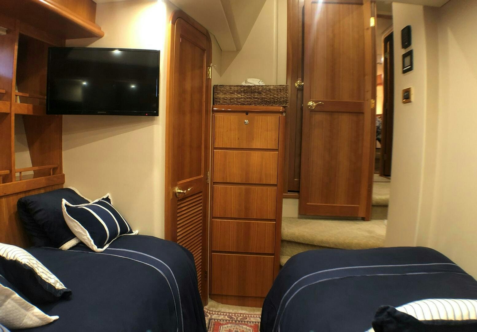a bedroom with a bed and a television aboard ENCHANTRESS Yacht for Sale