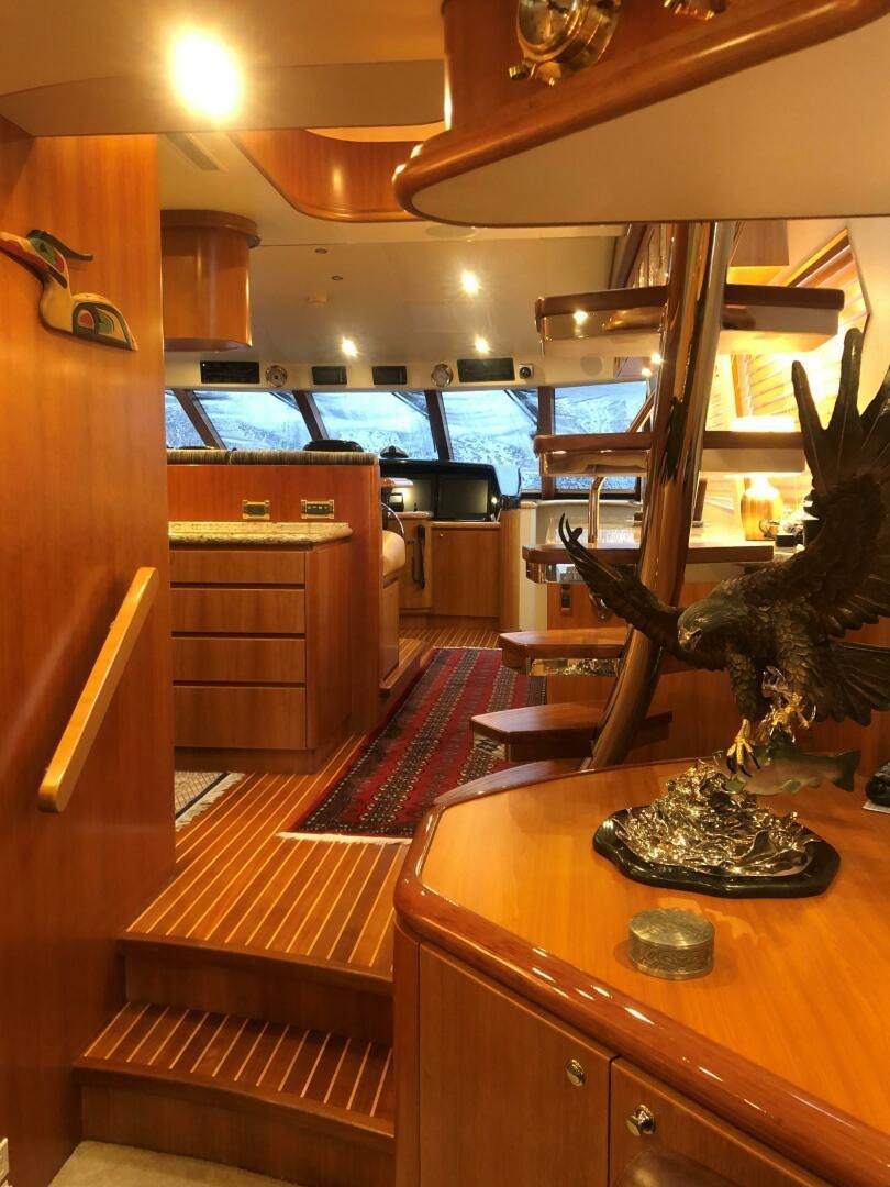 a room with a table and a chair aboard ENCHANTRESS Yacht for Sale