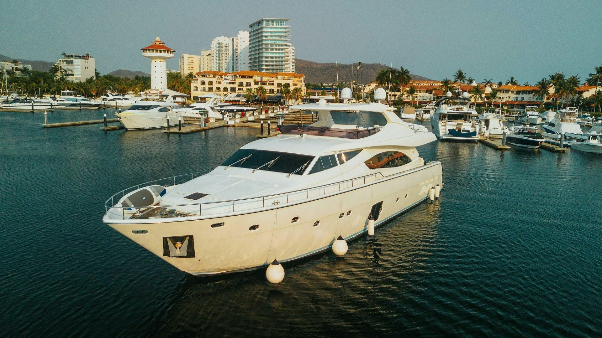 a white yacht in a harbor aboard LOS ESQUINKLES Yacht for Sale