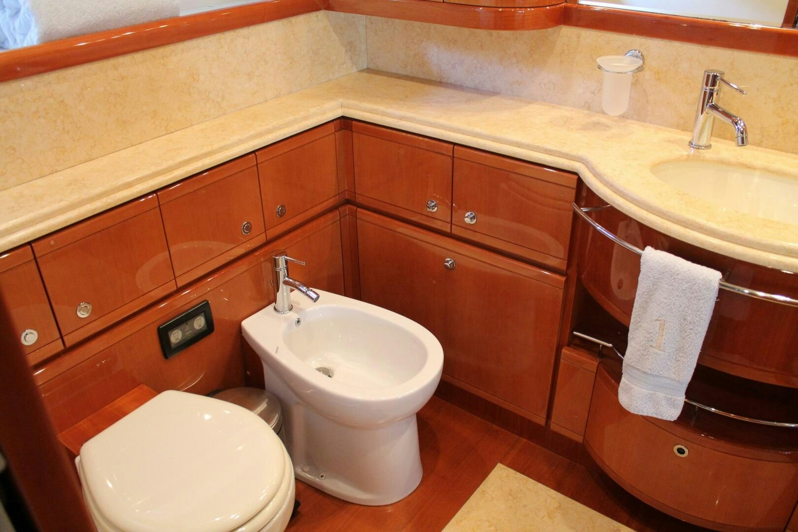 a bathroom with wooden cabinets aboard LOS ESQUINKLES Yacht for Sale