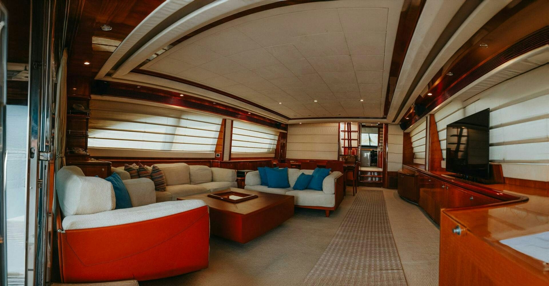 a living room with a couch and a television aboard LOS ESQUINKLES Yacht for Sale