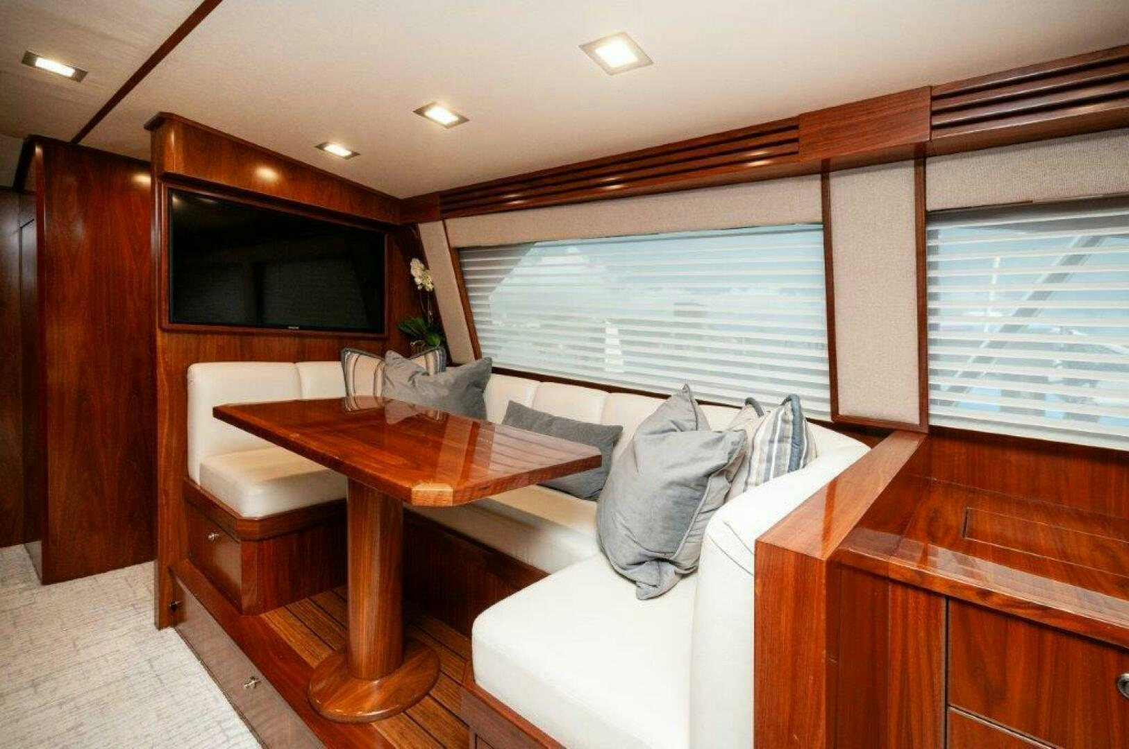 a room with a couch and a table aboard GUNNSLINGER Yacht for Sale