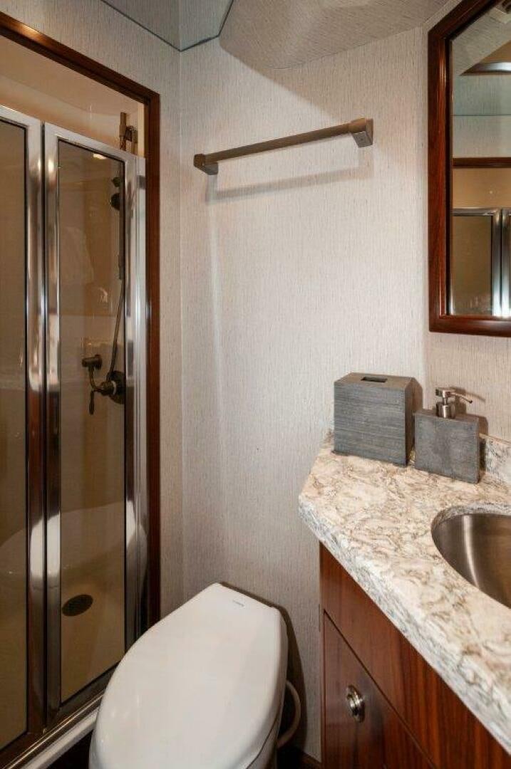 a bathroom with a toilet and a sink aboard GUNNSLINGER Yacht for Sale