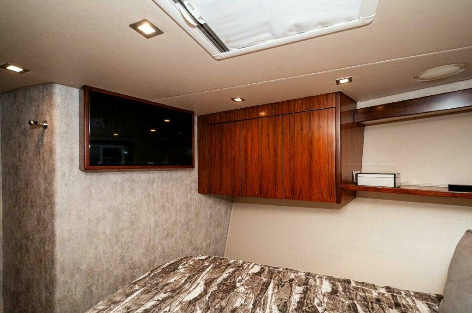 a room with a tv and a bed aboard GUNNSLINGER Yacht for Sale