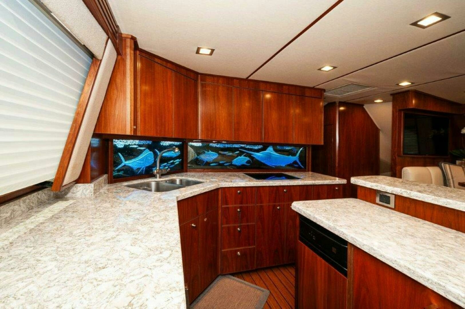 a kitchen with wooden cabinets aboard GUNNSLINGER Yacht for Sale