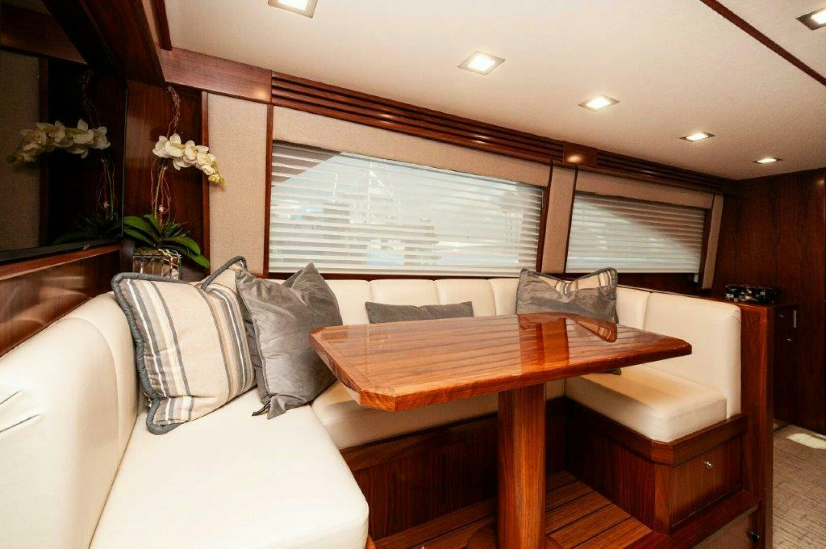 a room with a couch and a table aboard GUNNSLINGER Yacht for Sale