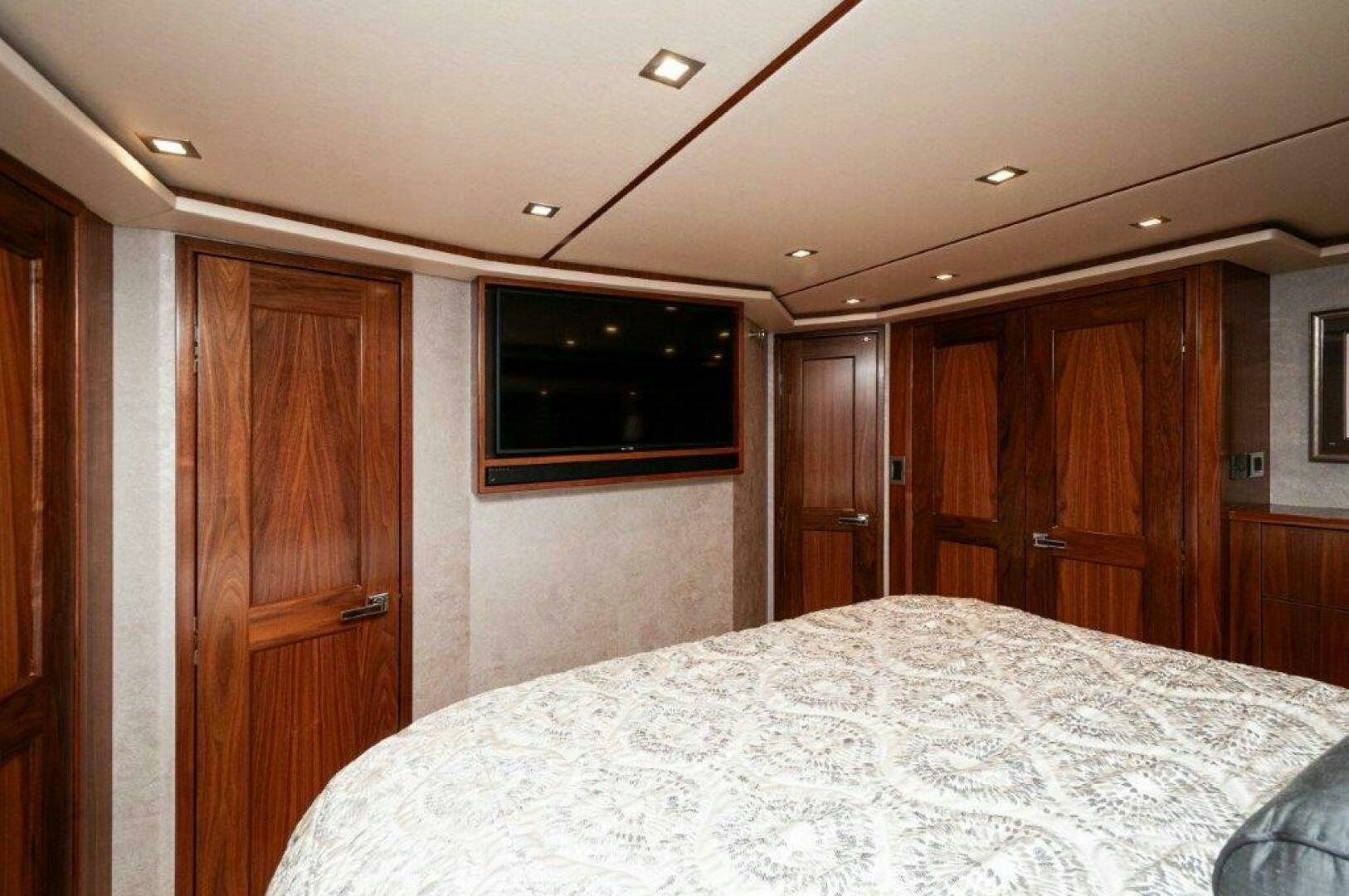 a bedroom with a bed and a closet aboard GUNNSLINGER Yacht for Sale