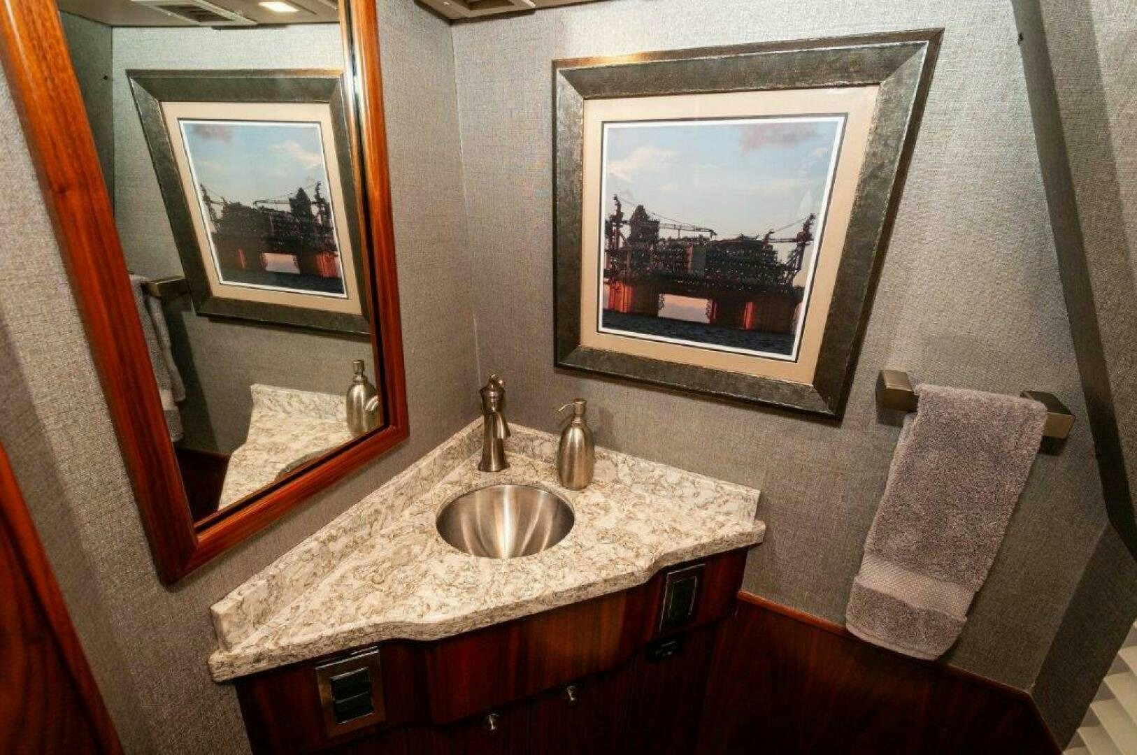 a bathroom with a sink and a painting on the wall aboard GUNNSLINGER Yacht for Sale