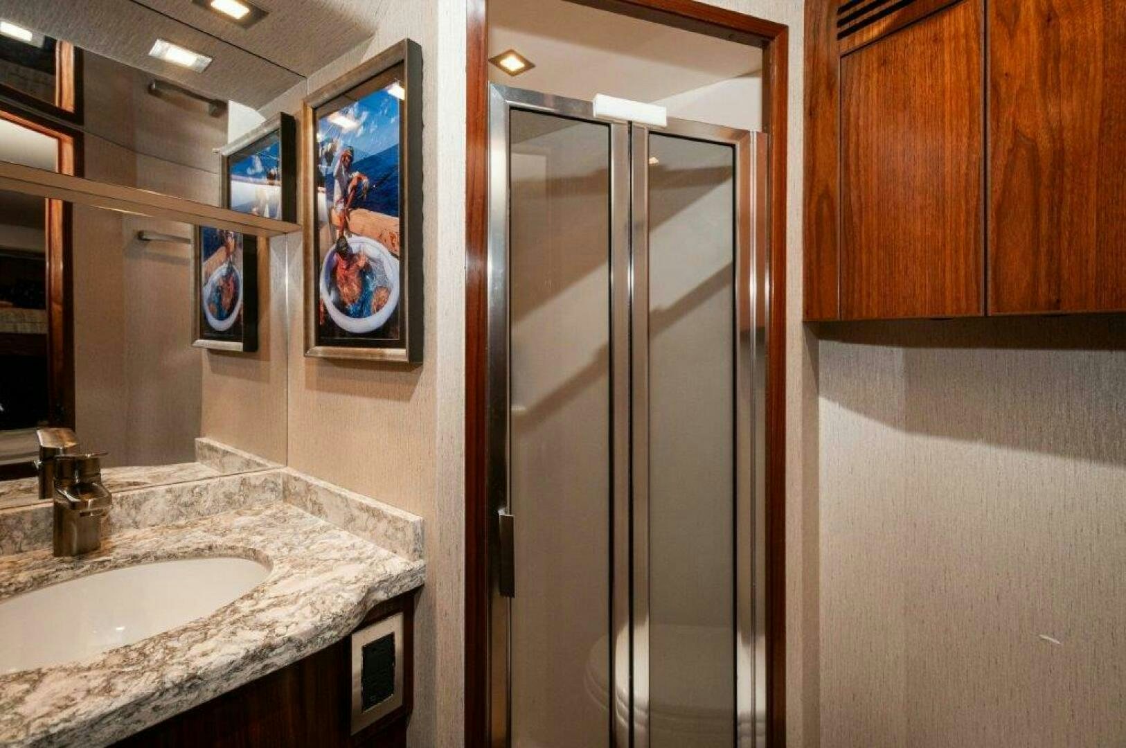 a bathroom with a sink and a shower unit aboard GUNNSLINGER Yacht for Sale