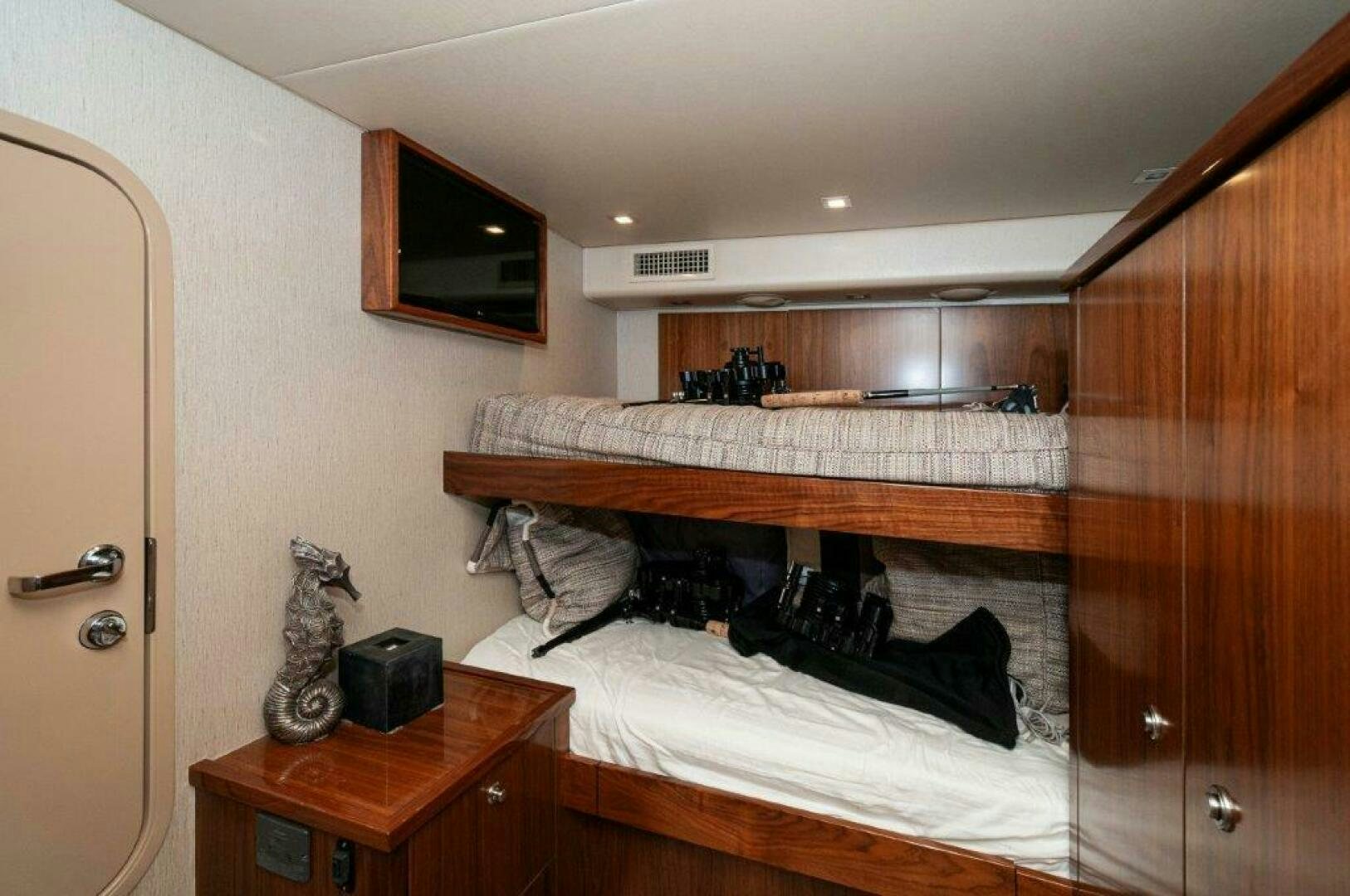 a room with a bed and a dresser aboard GUNNSLINGER Yacht for Sale