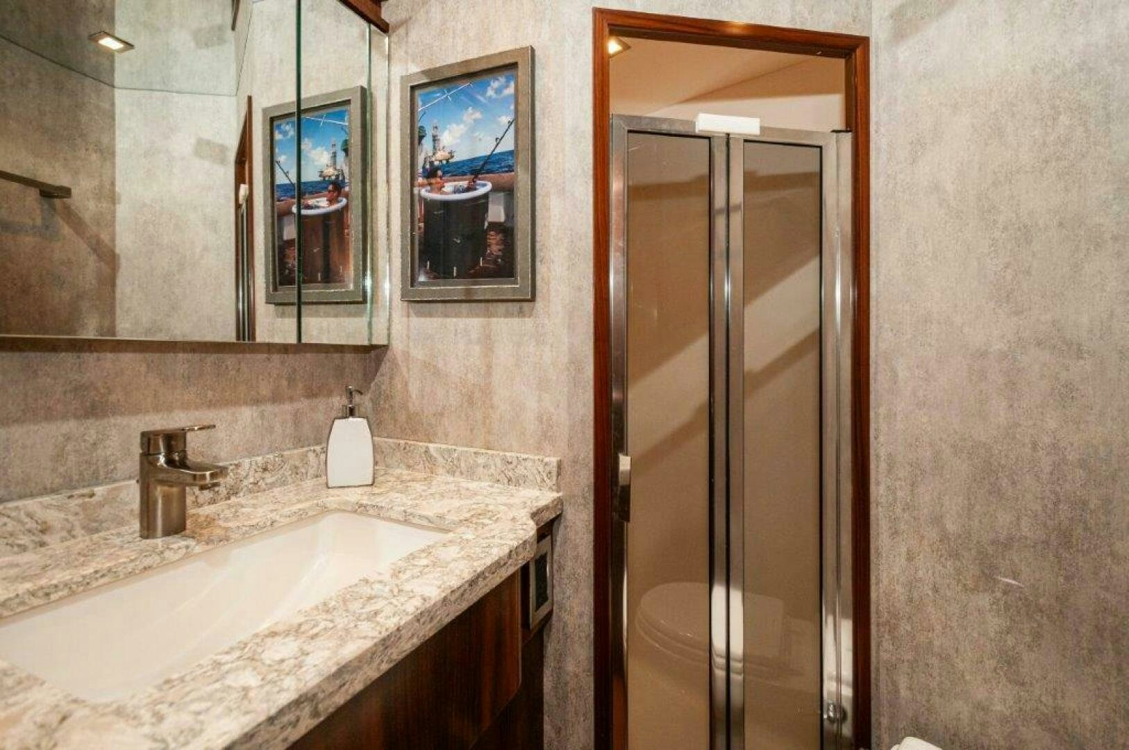 a bathroom with a sink and a shower aboard GUNNSLINGER Yacht for Sale