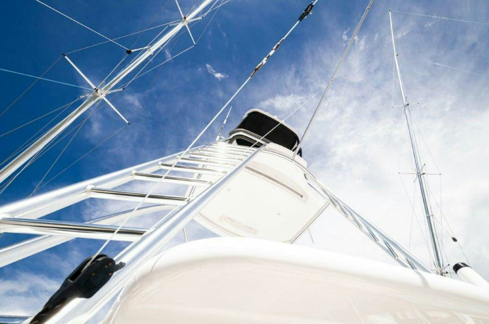 a white boat with a black tower aboard GUNNSLINGER Yacht for Sale