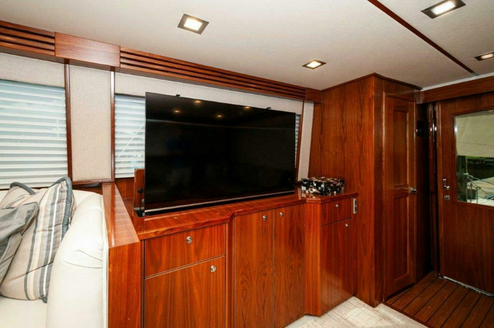 a room with wooden cabinets and a television aboard GUNNSLINGER Yacht for Sale