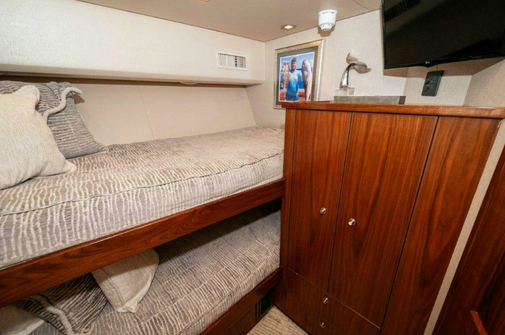 a bed with a white comforter aboard GUNNSLINGER Yacht for Sale