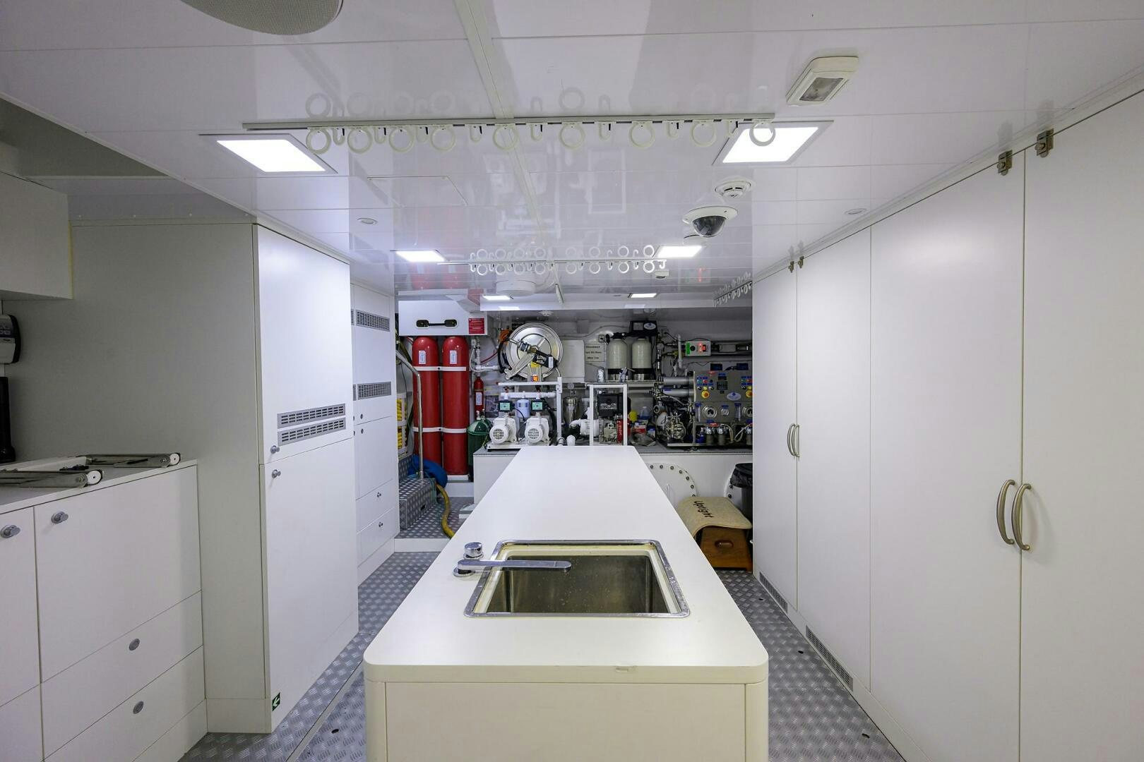 a kitchen with white cabinets aboard UPTIGHT Yacht for Sale