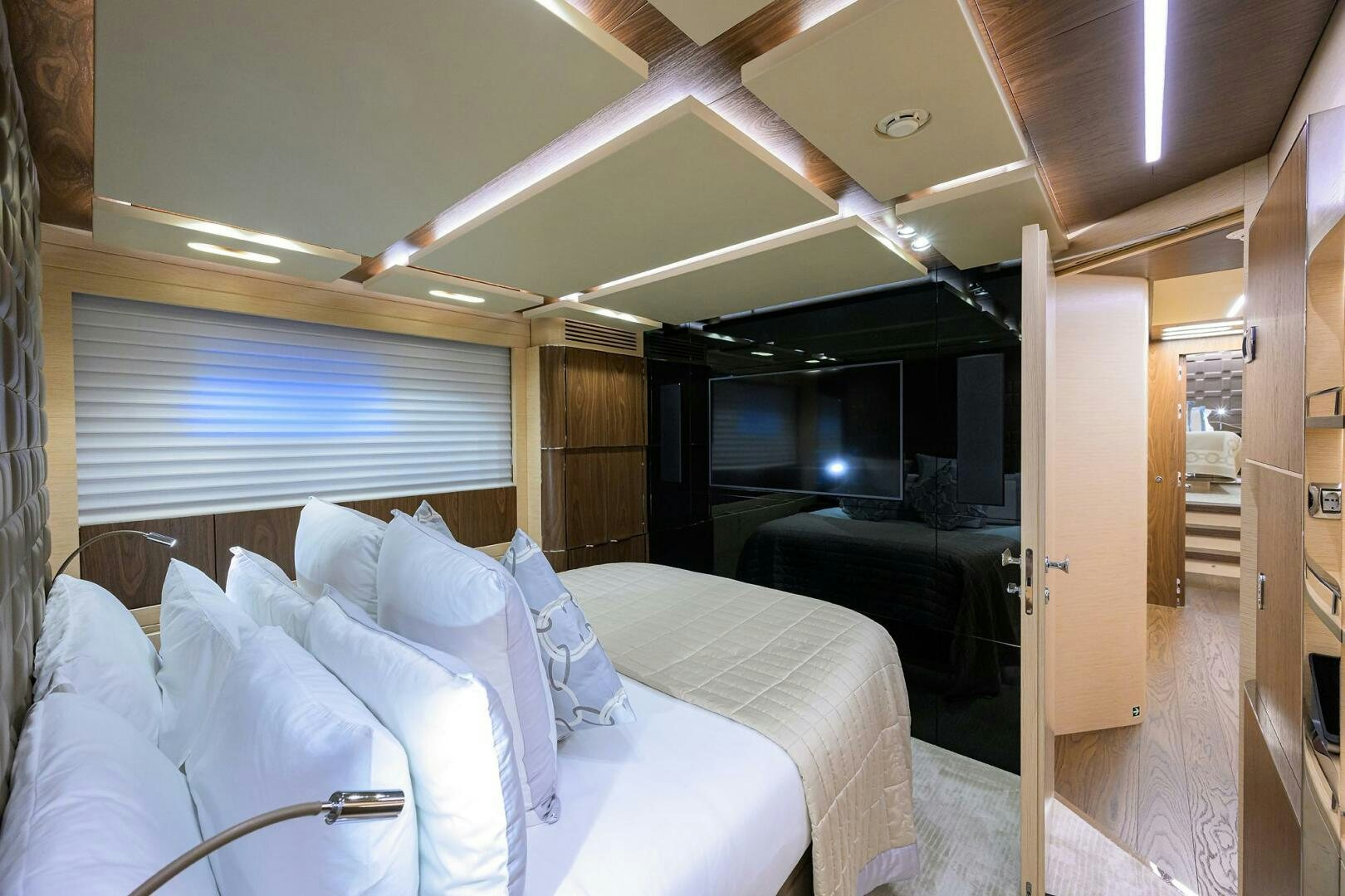 a room with a bed and a couch aboard UPTIGHT Yacht for Sale