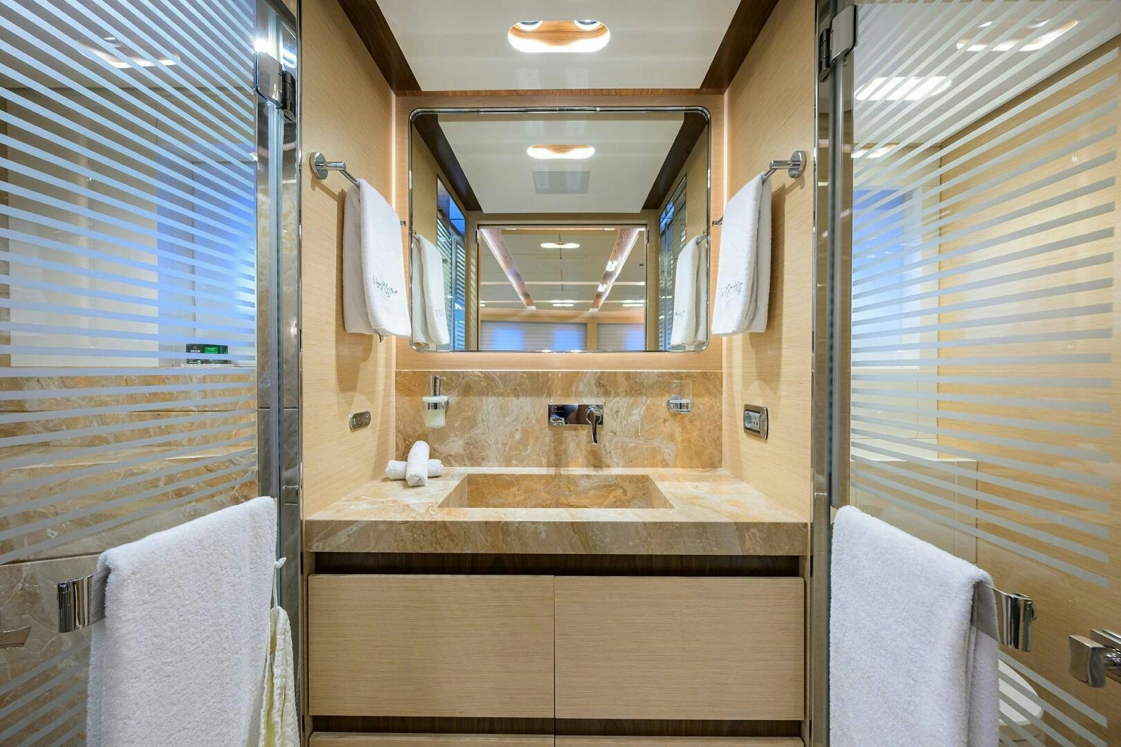 a bathroom with a sink and a mirror aboard UPTIGHT Yacht for Sale