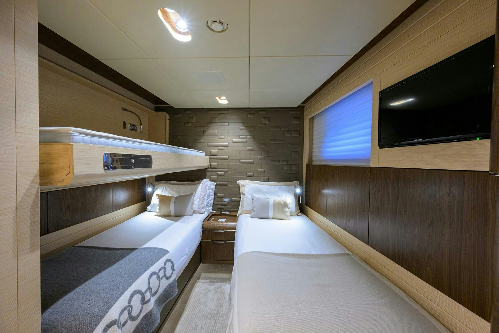 a room with a bed and a tv aboard UPTIGHT Yacht for Sale