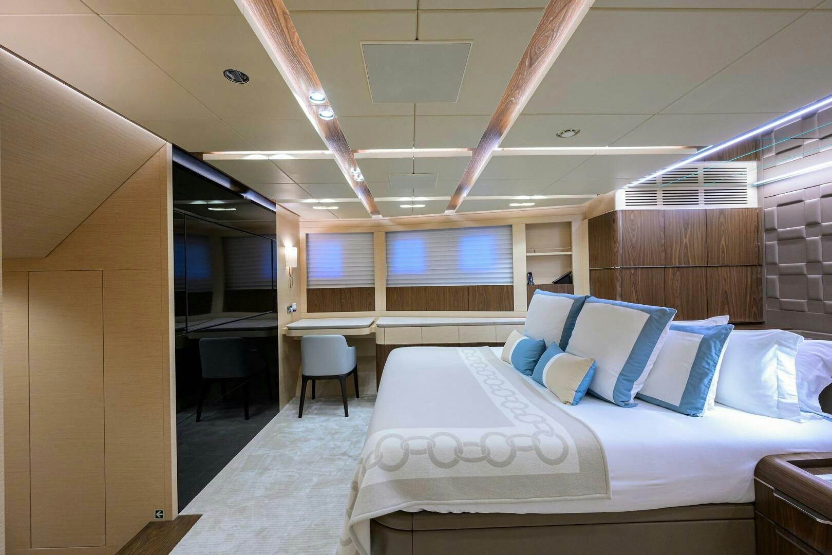 a room with a bed and a chair aboard UPTIGHT Yacht for Sale