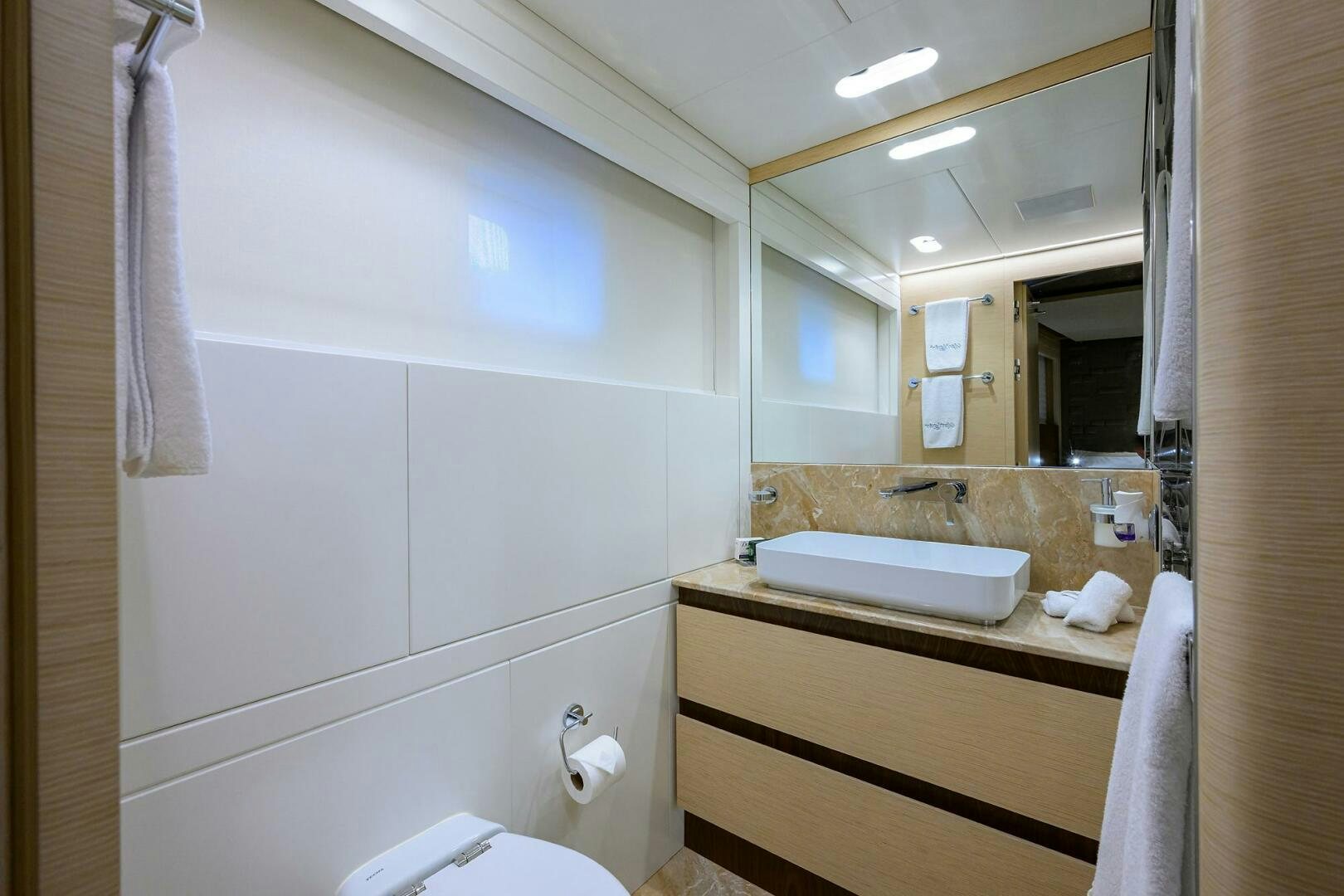 a bathroom with a sink and a mirror aboard UPTIGHT Yacht for Sale