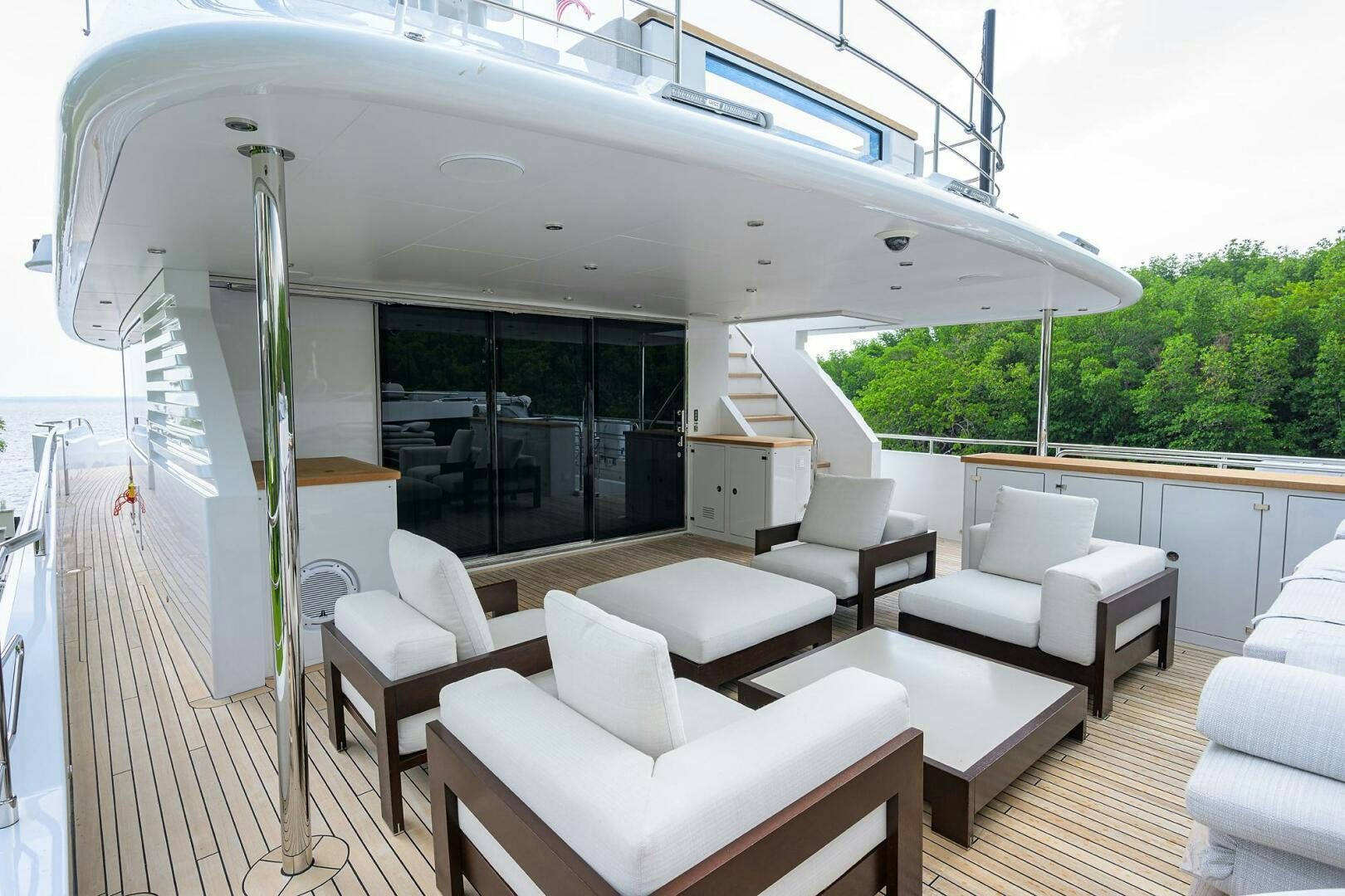 a room with a large white awning and chairs and a table with chairs and a large white aboard UPTIGHT Yacht for Sale