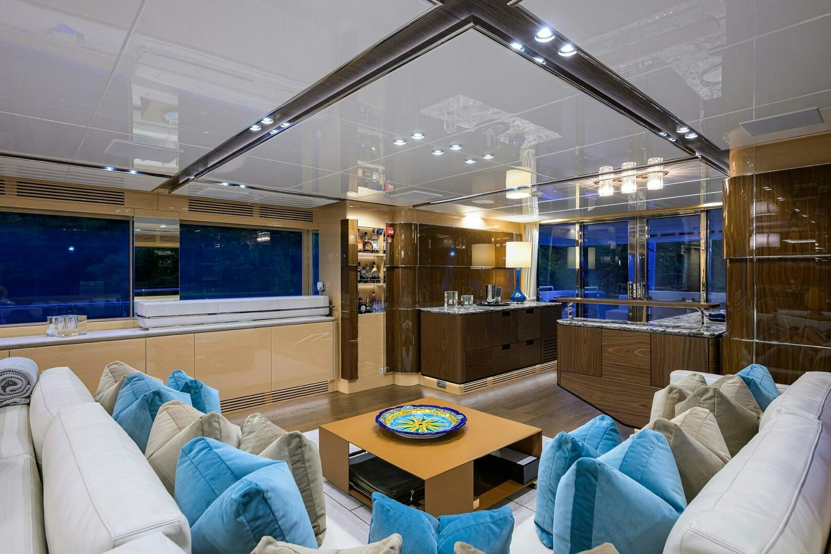 a living room with a table and couches aboard UPTIGHT Yacht for Sale