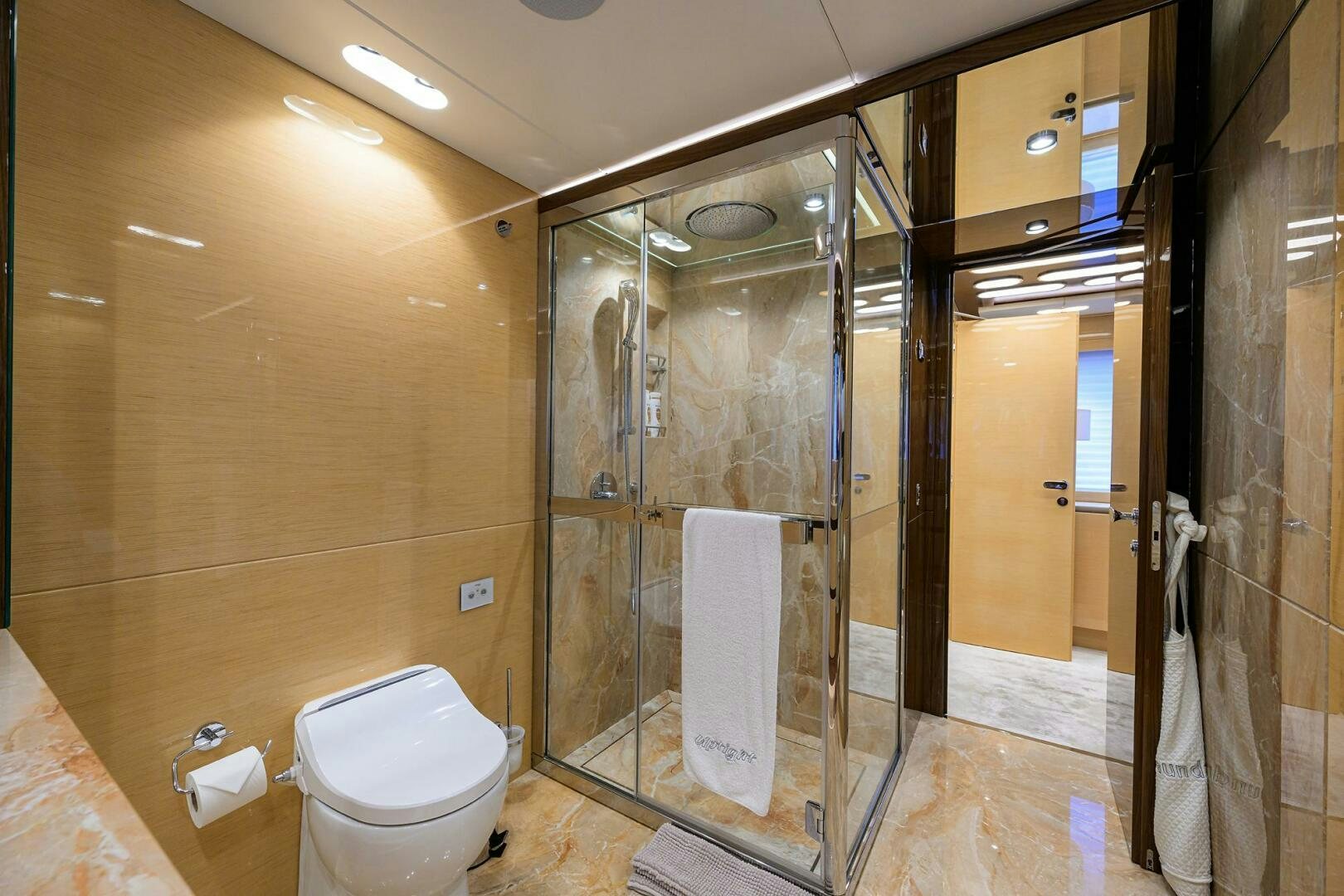 a bathroom with a glass shower aboard UPTIGHT Yacht for Sale