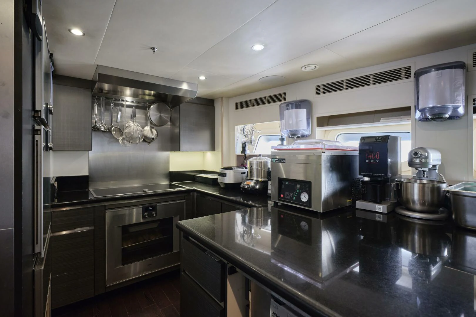 a kitchen with stainless steel appliances aboard SANAM Yacht for Sale