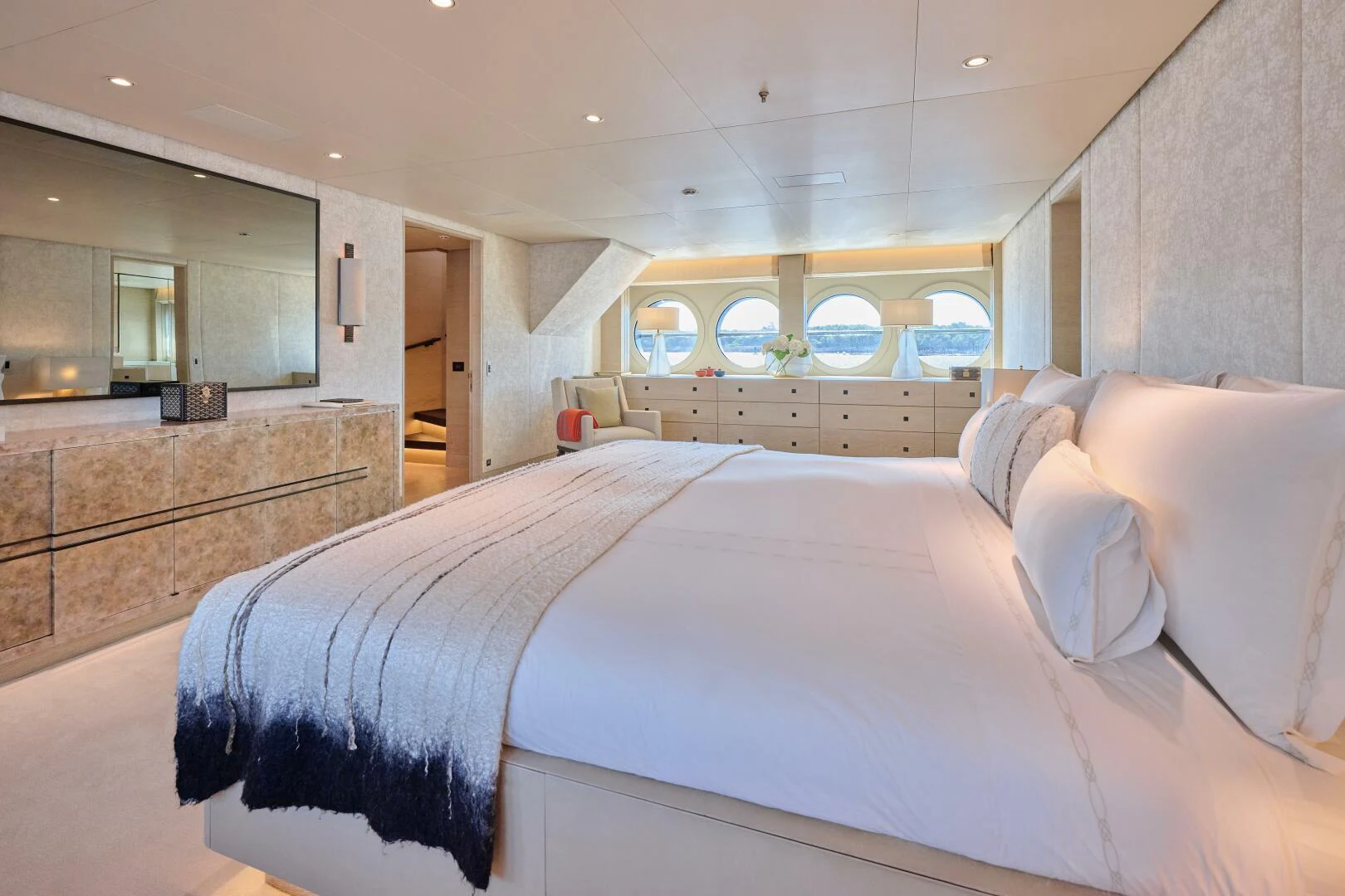 a bedroom with a bed and a wood cabinet aboard SANAM Yacht for Sale