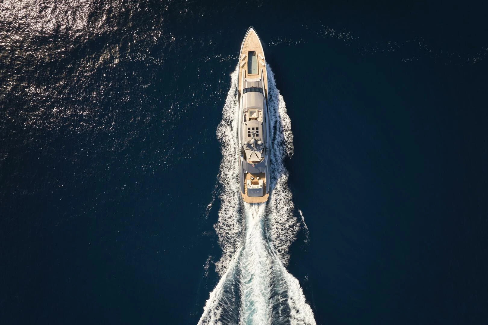 a rocket flying over the earth with Chrysler Building in the background aboard SANAM Yacht for Sale