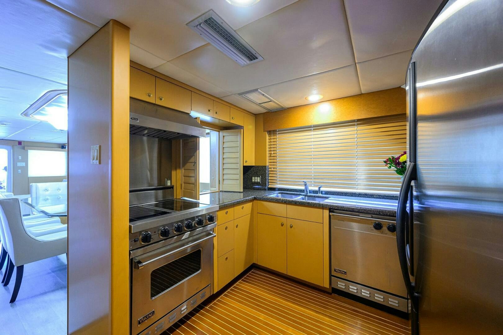 a kitchen with yellow cabinets aboard BUSINESS TRIP 2 Yacht for Sale