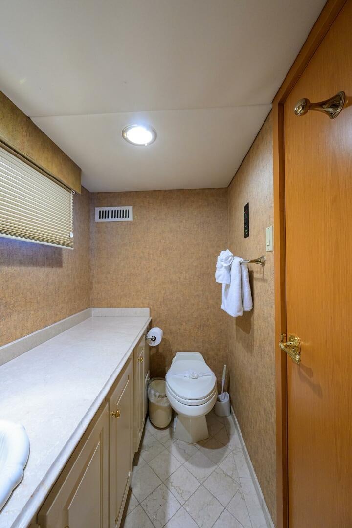 a bathroom with a toilet and sink aboard BUSINESS TRIP 2 Yacht for Sale