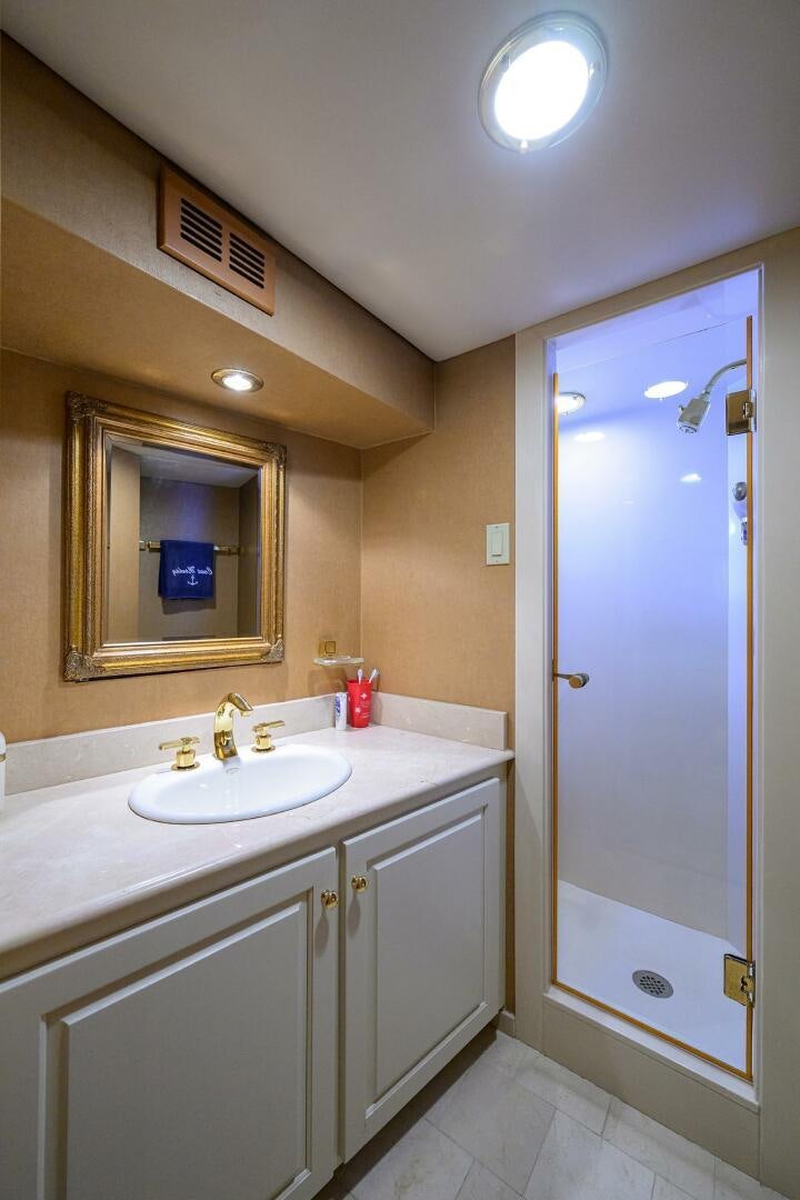 a bathroom with a sink and a mirror aboard BUSINESS TRIP 2 Yacht for Sale