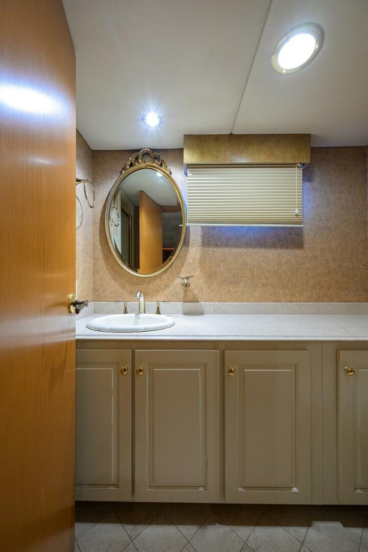 a bathroom with a mirror and a sink aboard BUSINESS TRIP 2 Yacht for Sale