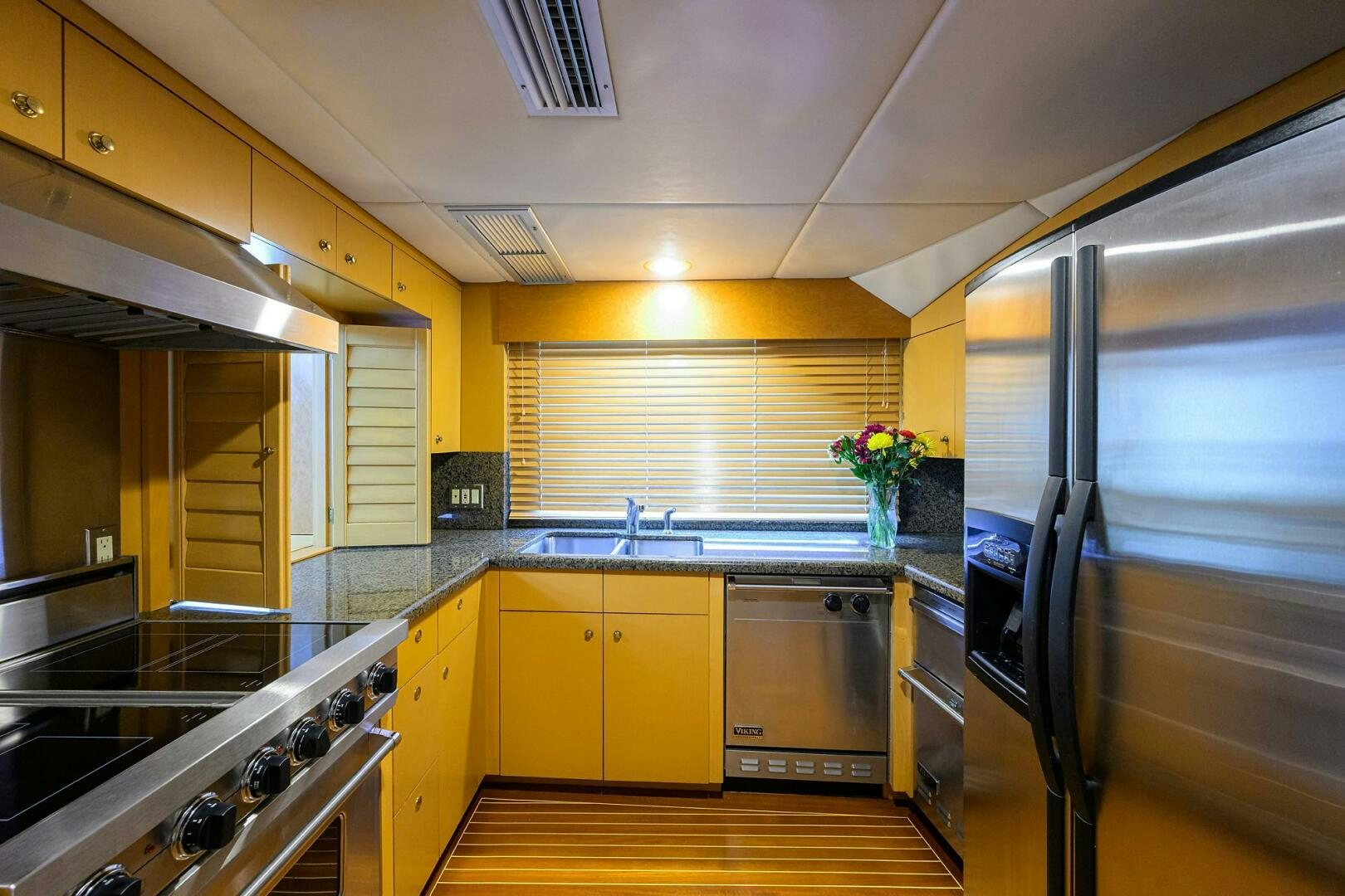 a kitchen with yellow cabinets aboard BUSINESS TRIP 2 Yacht for Sale