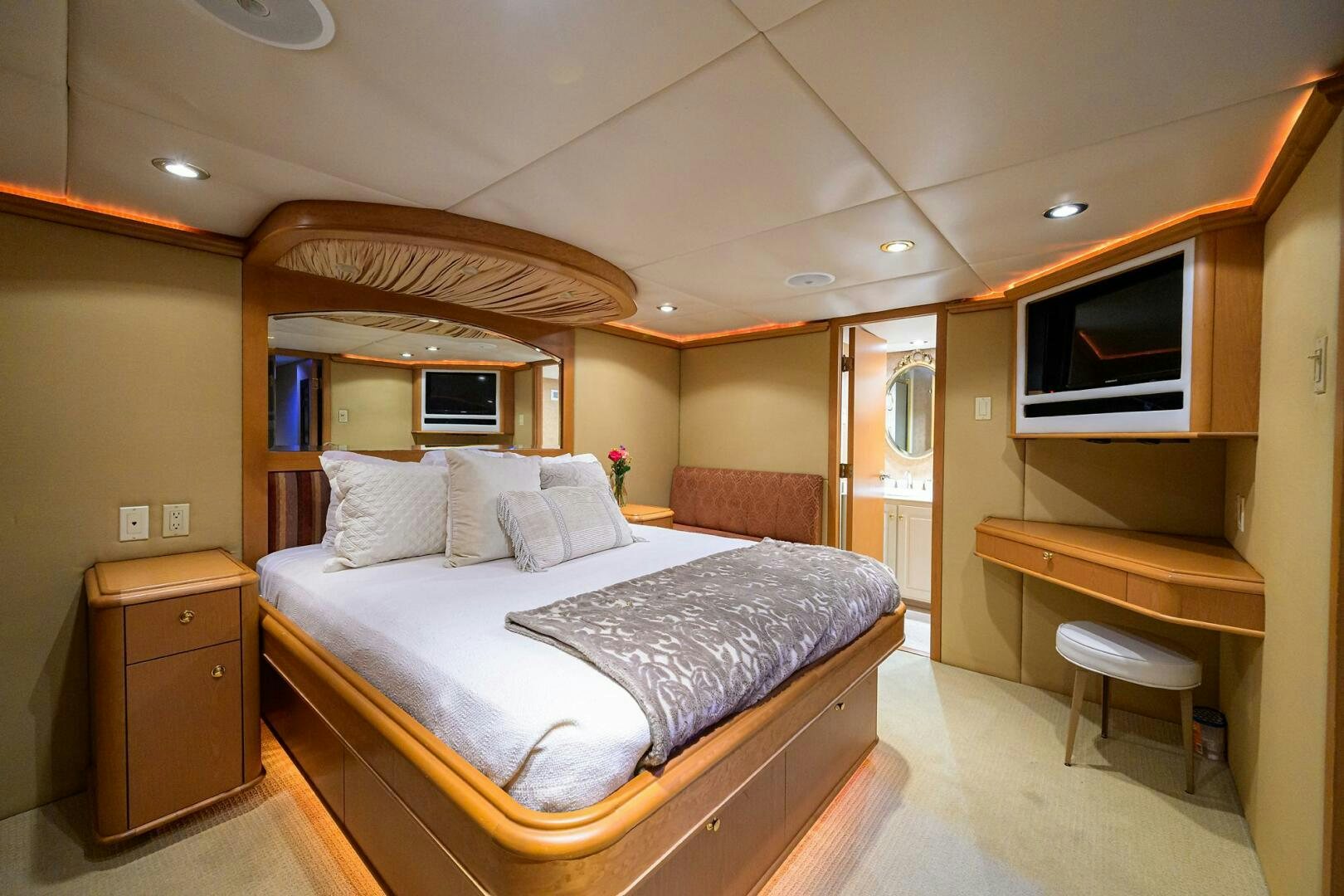 a bedroom with a bed and a desk aboard BUSINESS TRIP 2 Yacht for Sale