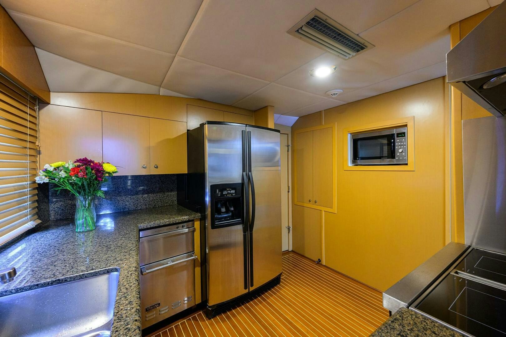 a kitchen with a stainless steel refrigerator aboard BUSINESS TRIP 2 Yacht for Sale