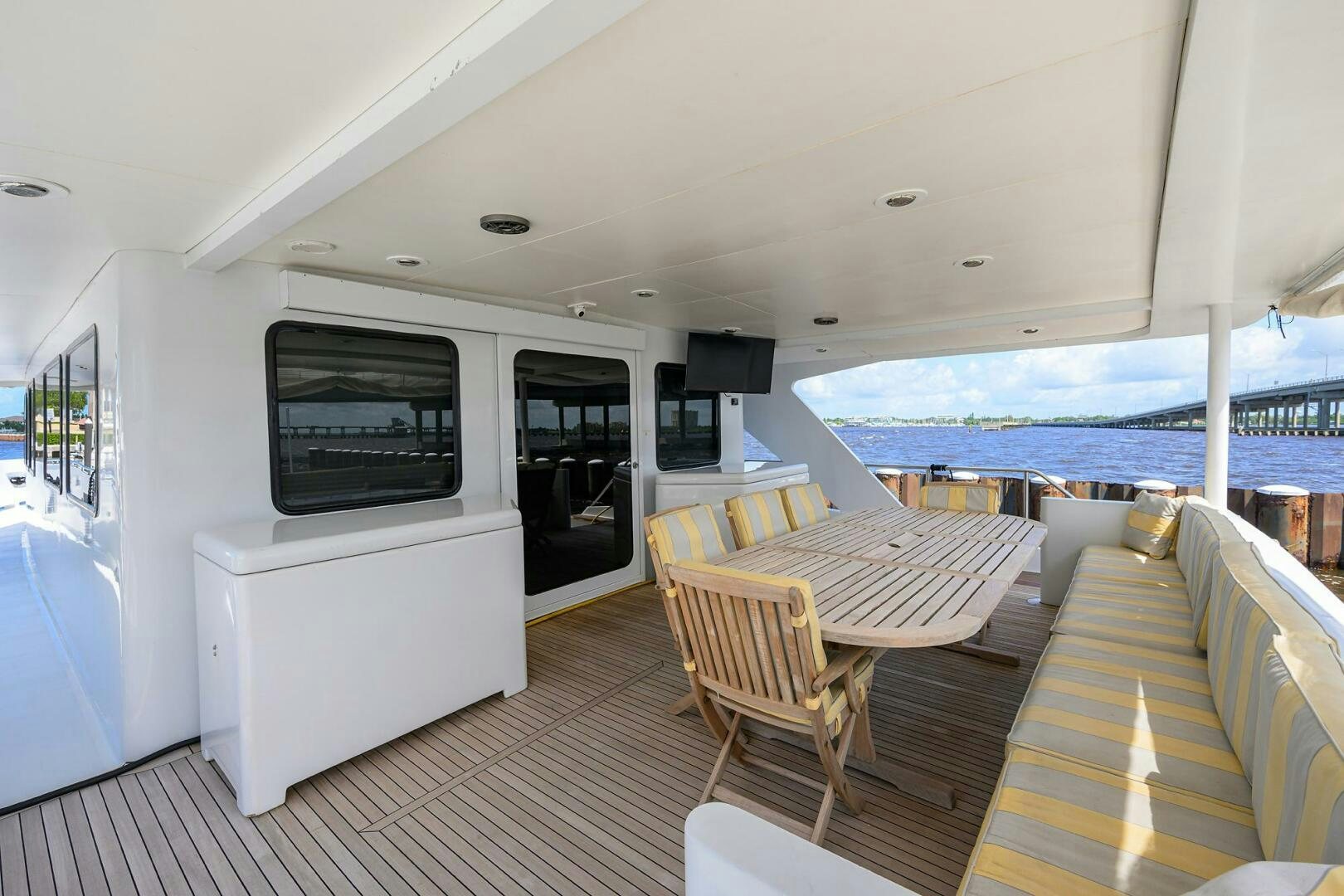 a living room with a large balcony aboard BUSINESS TRIP 2 Yacht for Sale