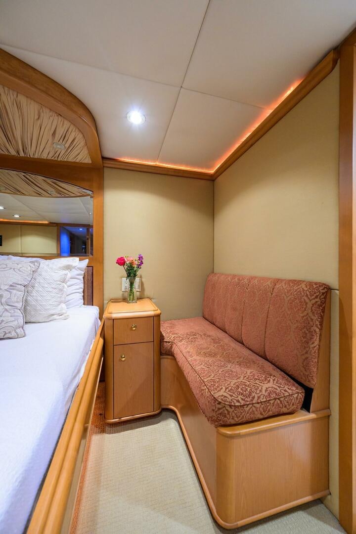 a bed and a chair in a room aboard BUSINESS TRIP 2 Yacht for Sale