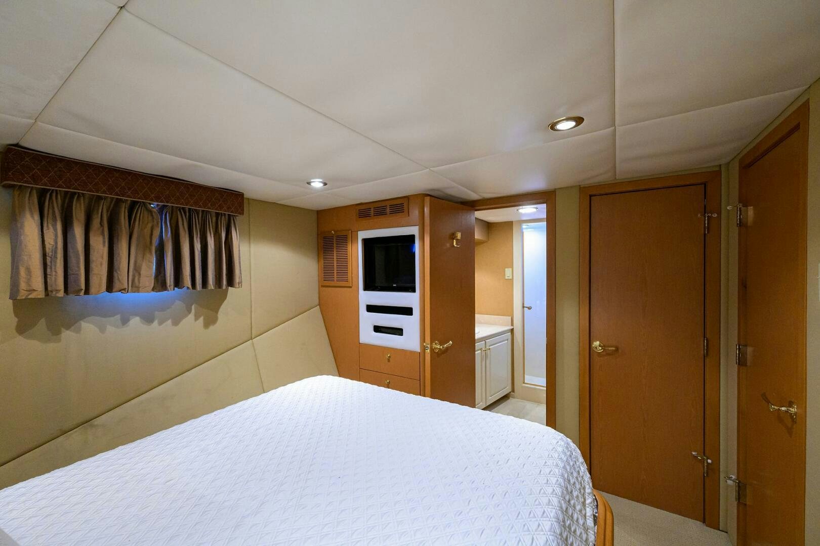 a bedroom with a bed and a closet aboard BUSINESS TRIP 2 Yacht for Sale