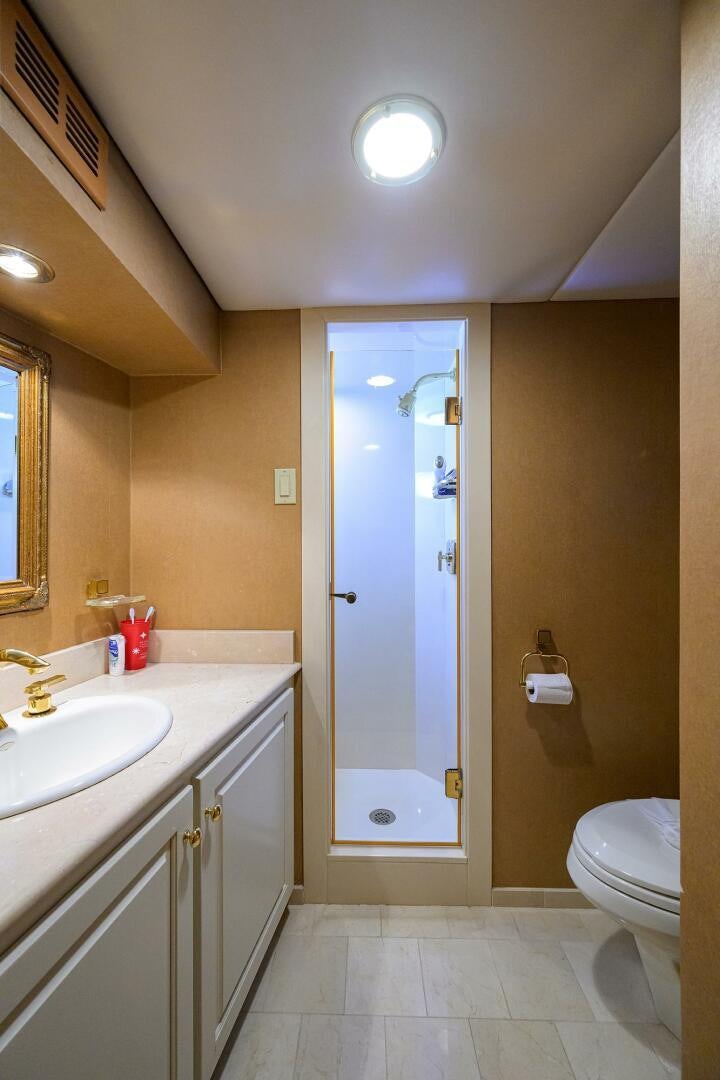 a bathroom with a shower and toilet aboard BUSINESS TRIP 2 Yacht for Sale