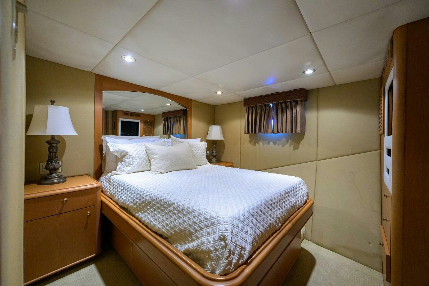 a bedroom with a bed and a lamp aboard BUSINESS TRIP 2 Yacht for Sale