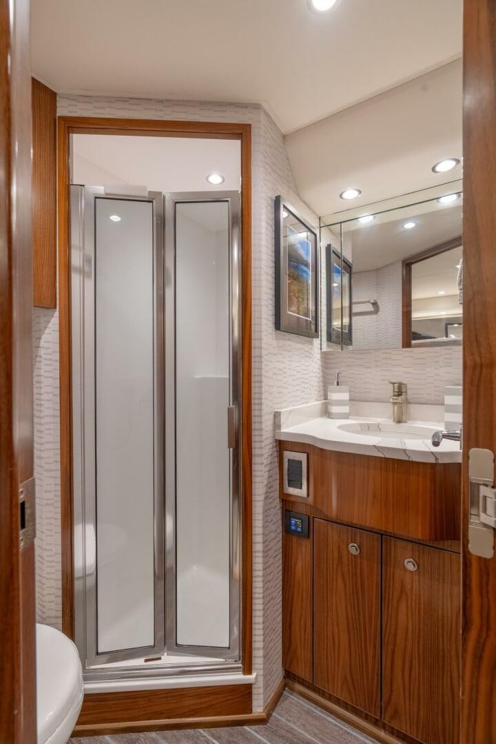 a bathroom with a glass shower aboard REEL CENTS Yacht for Sale